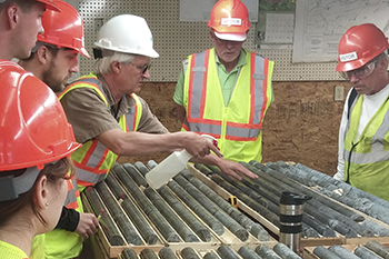 Photo of People examining Rock Layer Samples