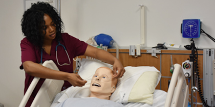 Nurse treating simulated patient