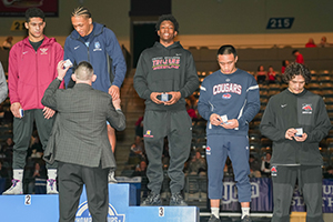 Wrestling Athletes on Podium receiving awards