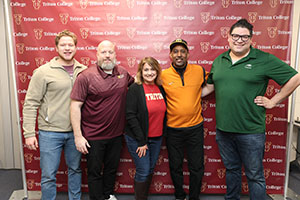 Lance Johnson posing with Alumni Members