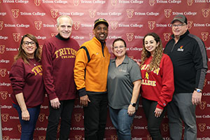 Lance Johnson posing with Alumni Members