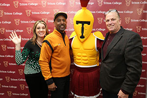 Troy the Mascot and Lance Johnson posing with Alumni Members