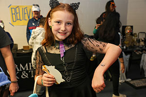 Girl dressed as a cat for Halloween at Trunk or Treat in space 