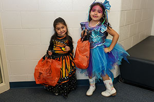 Two young girls dressed in costume at Trunk or Treat