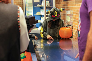 Trunk or Treat 2025 15 Kids in costumes looking at plasma screen in Cernan Center at Trunk or Treat