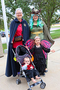 Family dressed in costume for Halloween at Trunk or Treat in space
