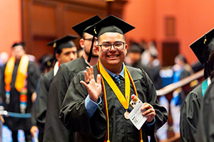 Photo of Graduate waving at camera