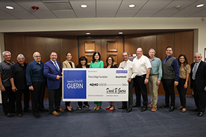 Photo of President Moore and Mayor Guerin with Foundation Members posing with giant check