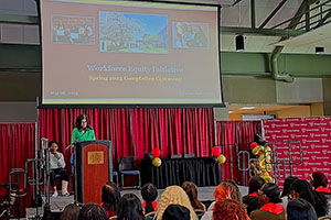 Photo of President Moore at podium addressing WEI graduates